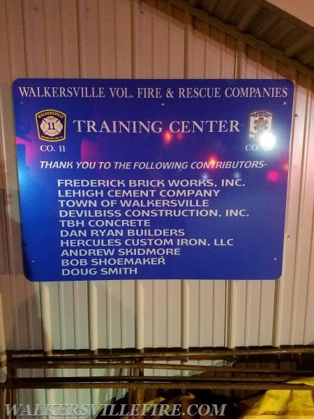 Dedication sign for training building on fire company grounds.